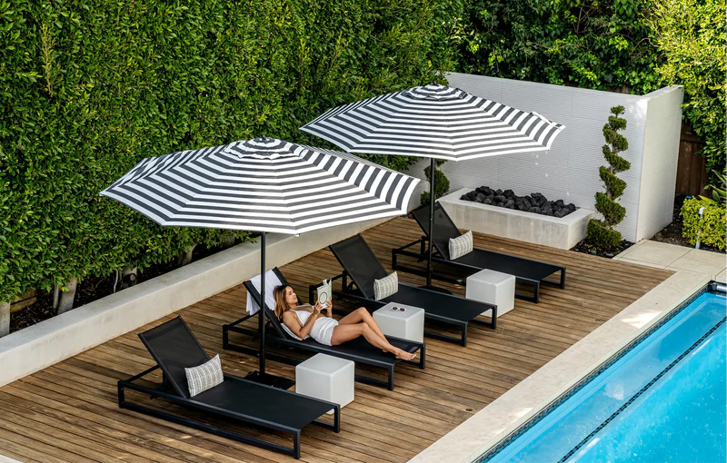 Cantilever umbrellas shading resort poolside loungers