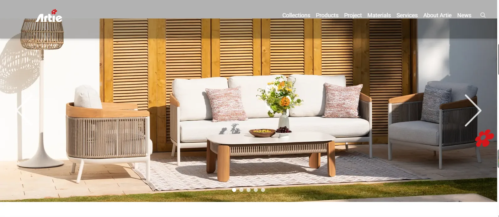 An Artie Garden outdoor sofa, armchairs and coffee table against a timber slat wall