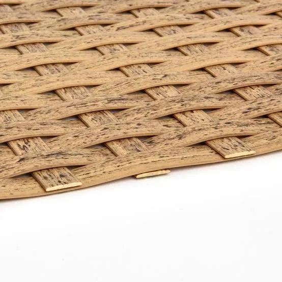 Macro close-up of woven synthetic rattan strands showing the flat-weave pattern