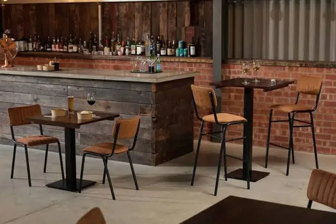 Buyer setting seat height and layout specs for a contract-grade bar stool order