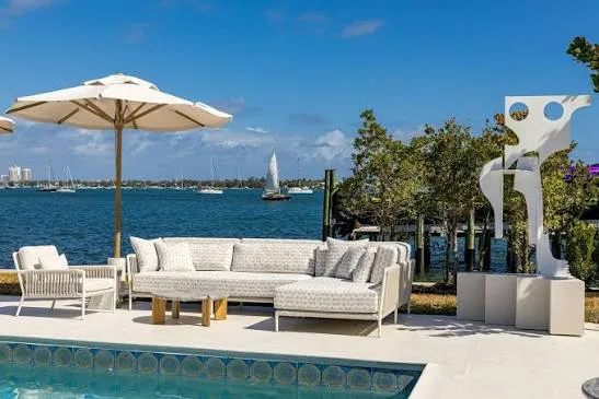 Resort beach club deck with sofas and umbrellas